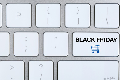 Computer keyboard with Black Friday button, closeup. Online shopping 