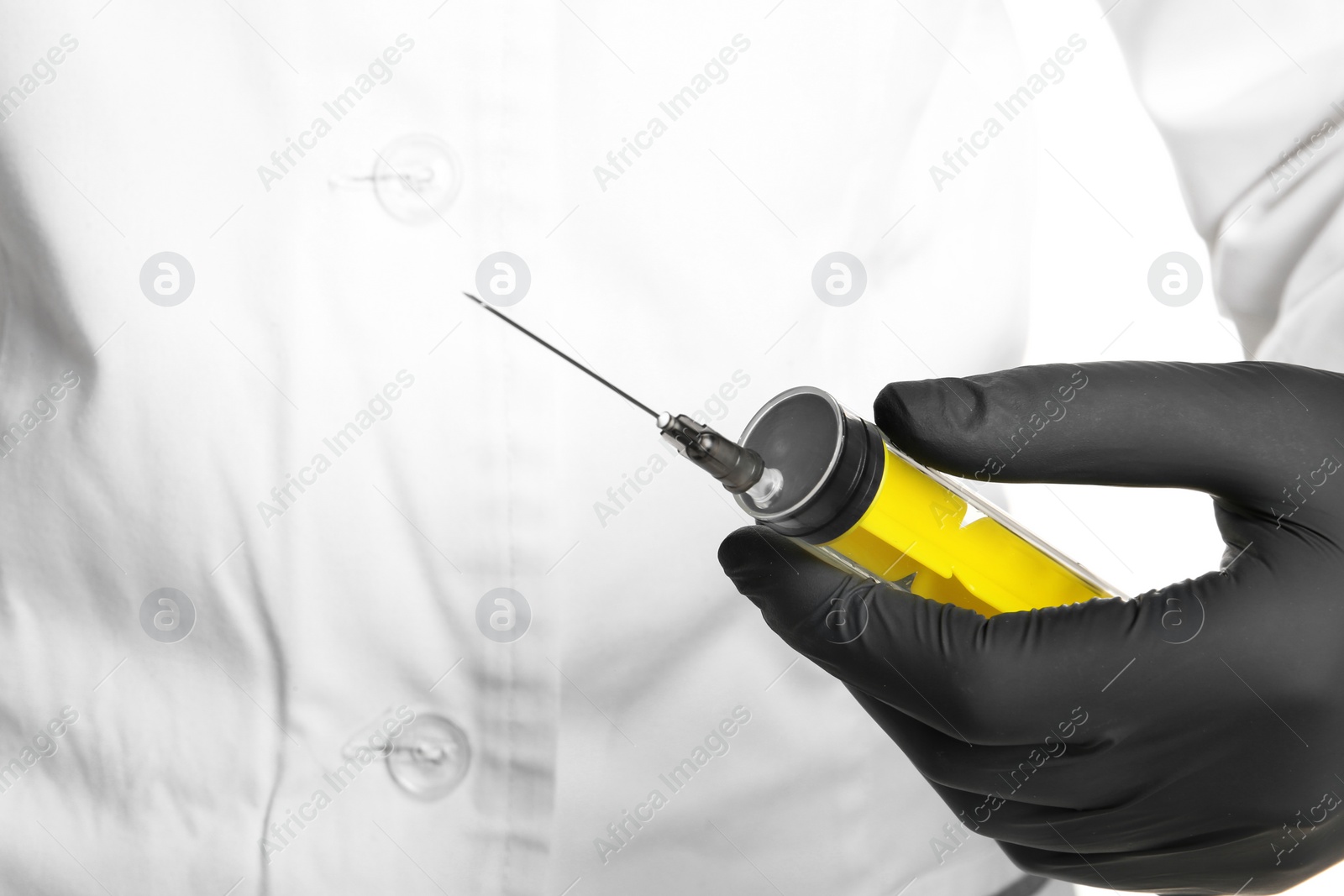 Photo of Doctor in medical glove holding empty syringe, closeup