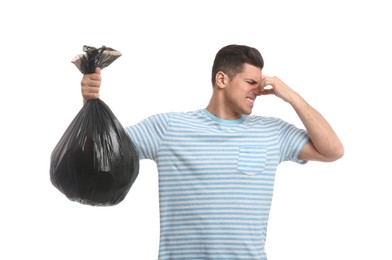 Man holding full garbage bag on white background