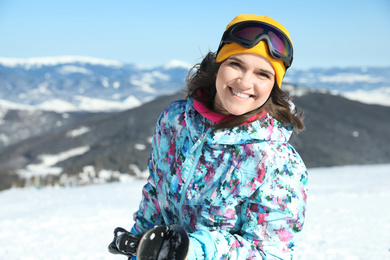 Photo of Happy young woman in mountains. Winter vacation