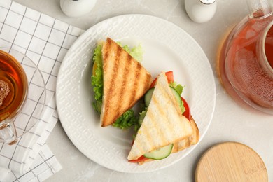 Photo of Delicious sandwiches with vegetables and cheese on light grey table, flat lay