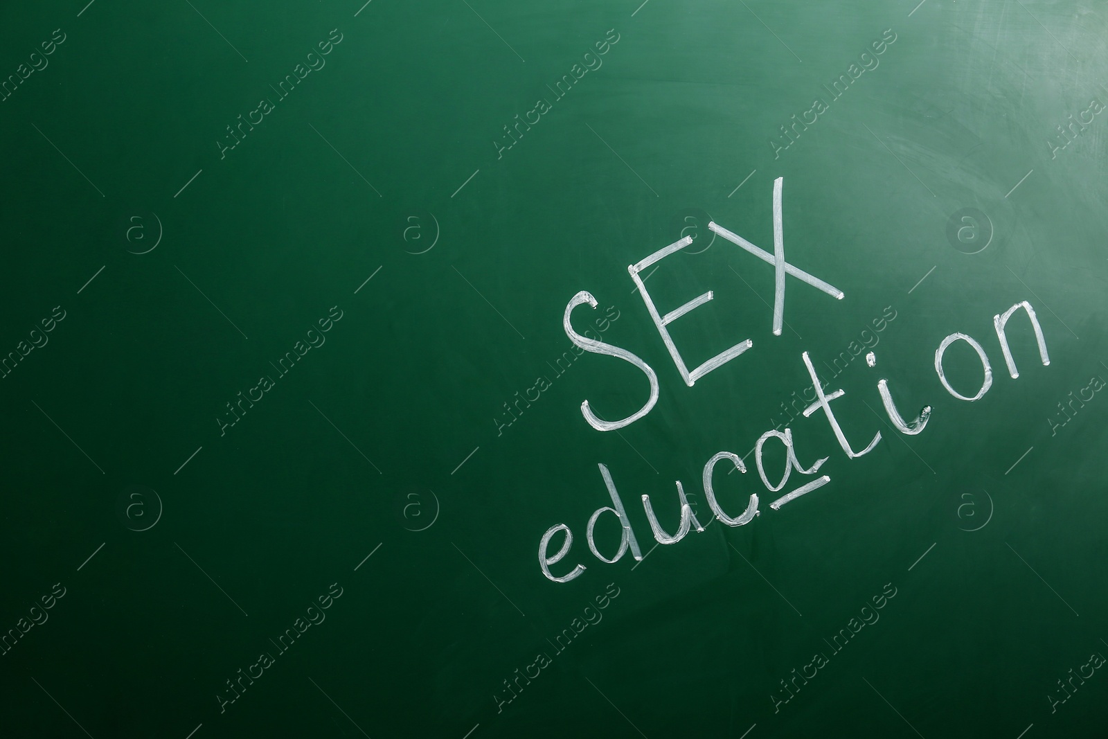 Photo of Phrase "SEX EDUCATION" written on green chalkboard. Space for text