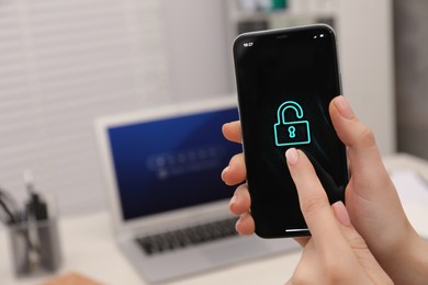 Photo of Woman holding smartphone with blocked screen at workplace, closeup. Space for text