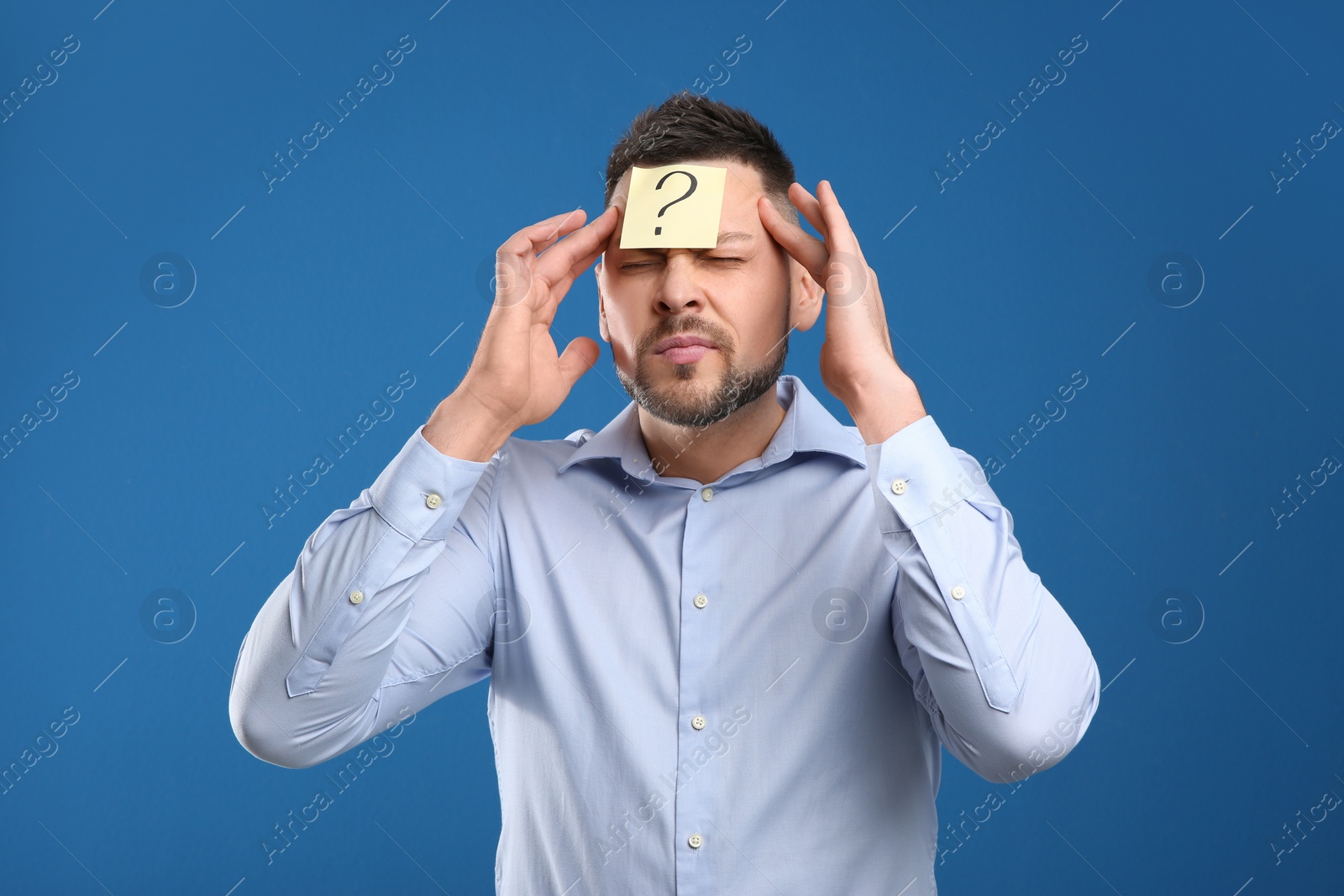 Photo of Emotional man with question mark on blue background