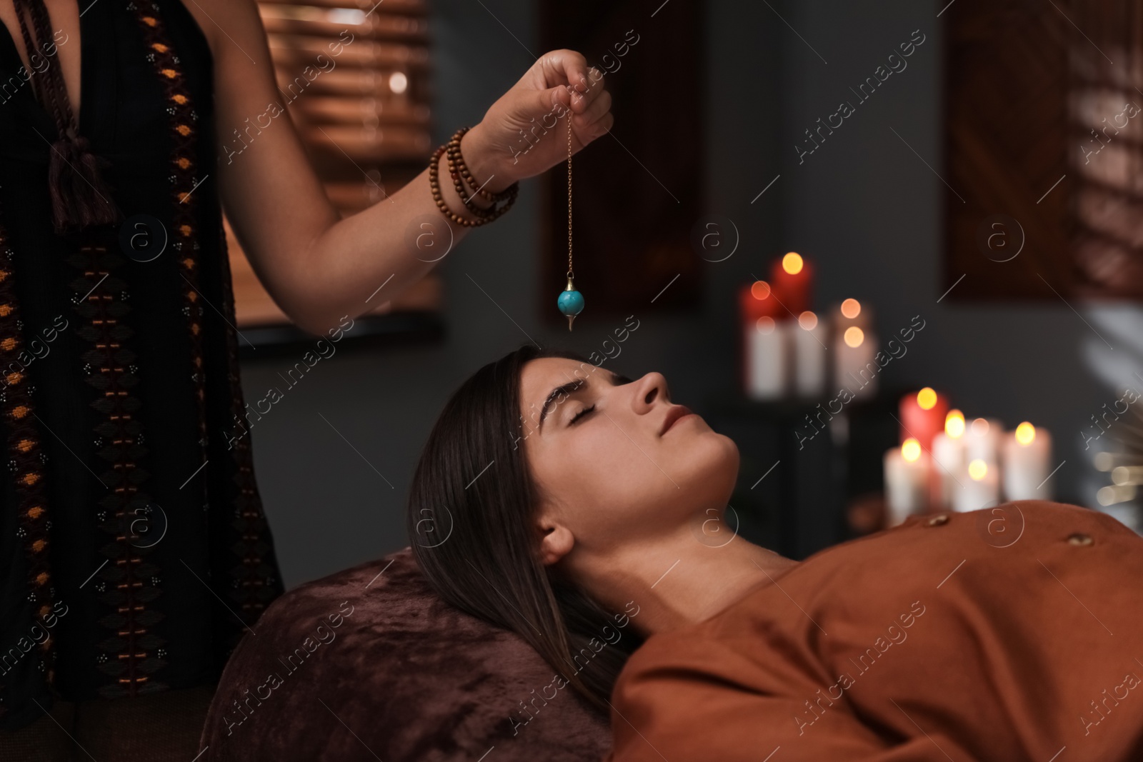 Photo of Woman at crystal healing session in dark room