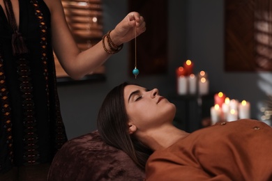 Photo of Woman at crystal healing session in dark room