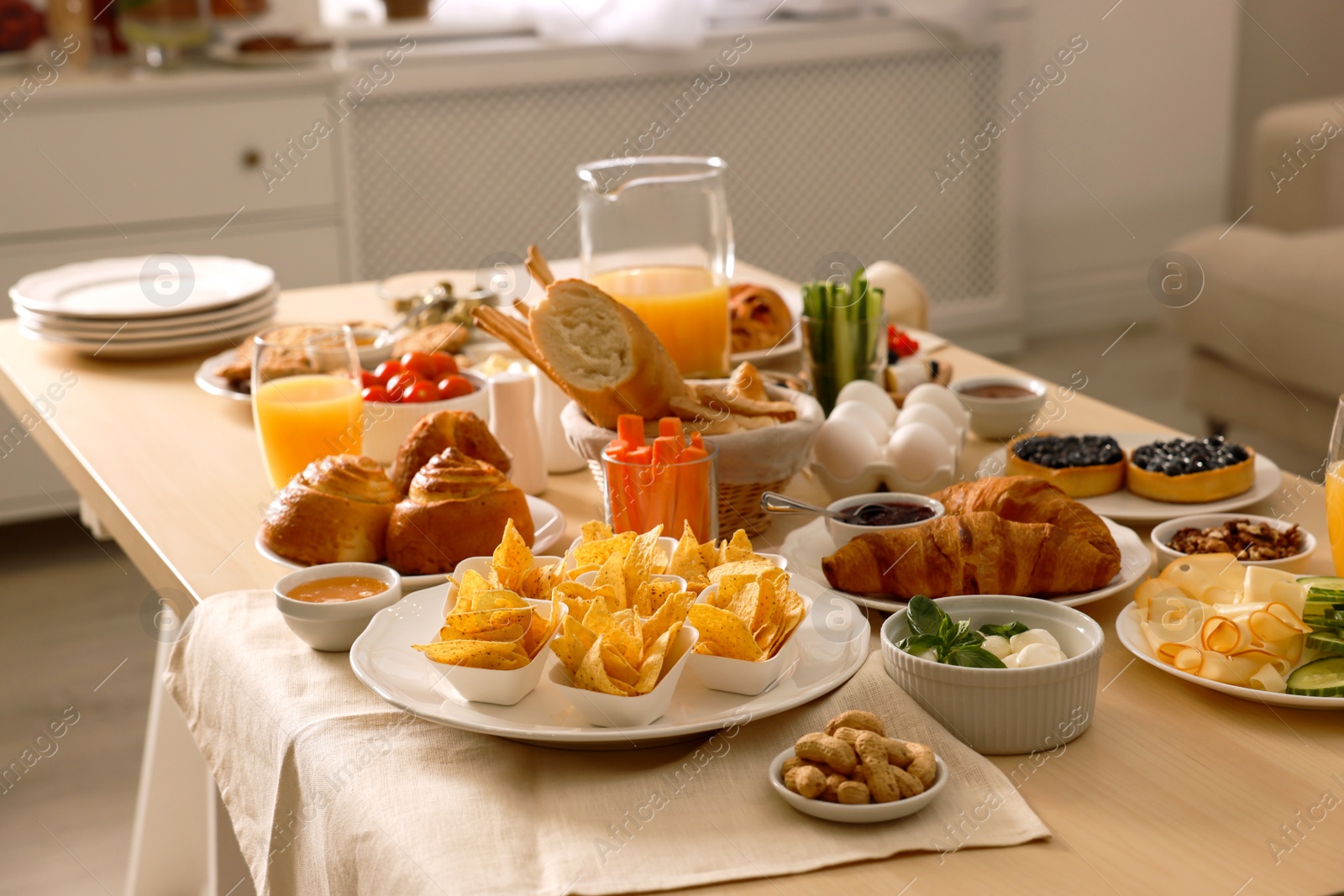 Photo of Dishes with different food on table in room. Luxury brunch