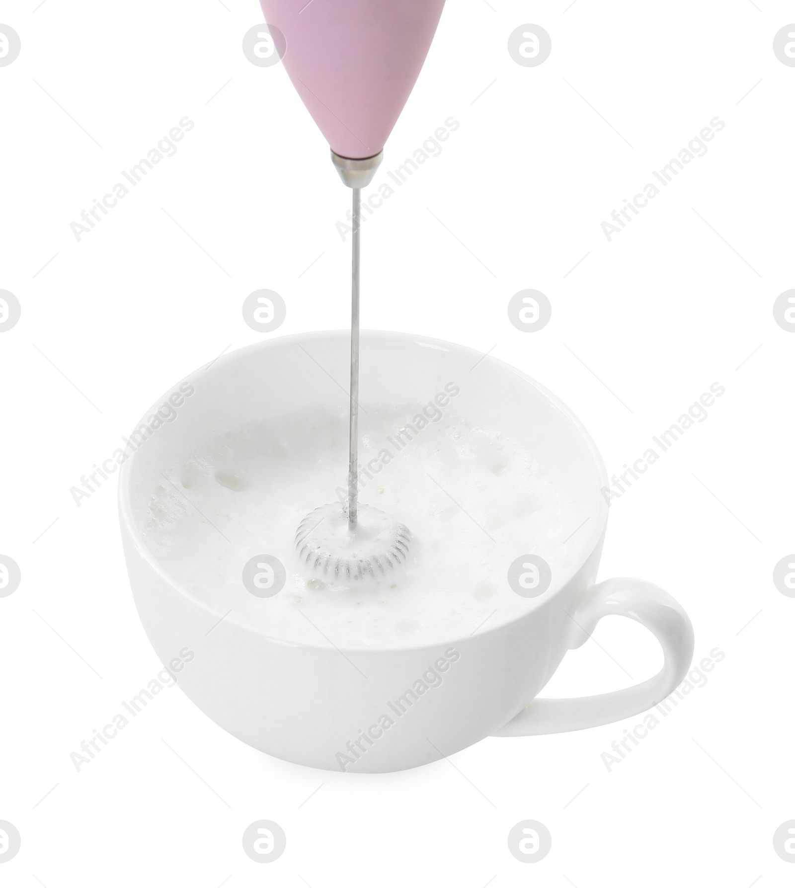 Photo of Whisking milk in cup with mini mixer (frother wand) isolated on white, closeup