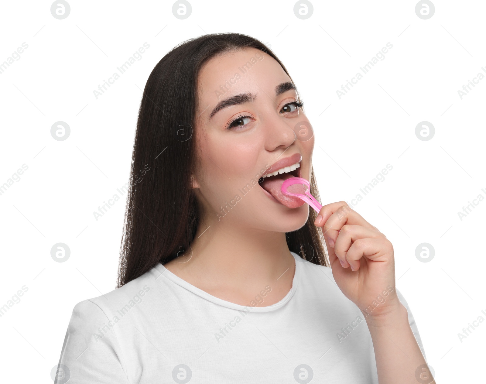 Photo of Happy woman brushing her tongue with cleaner on white background