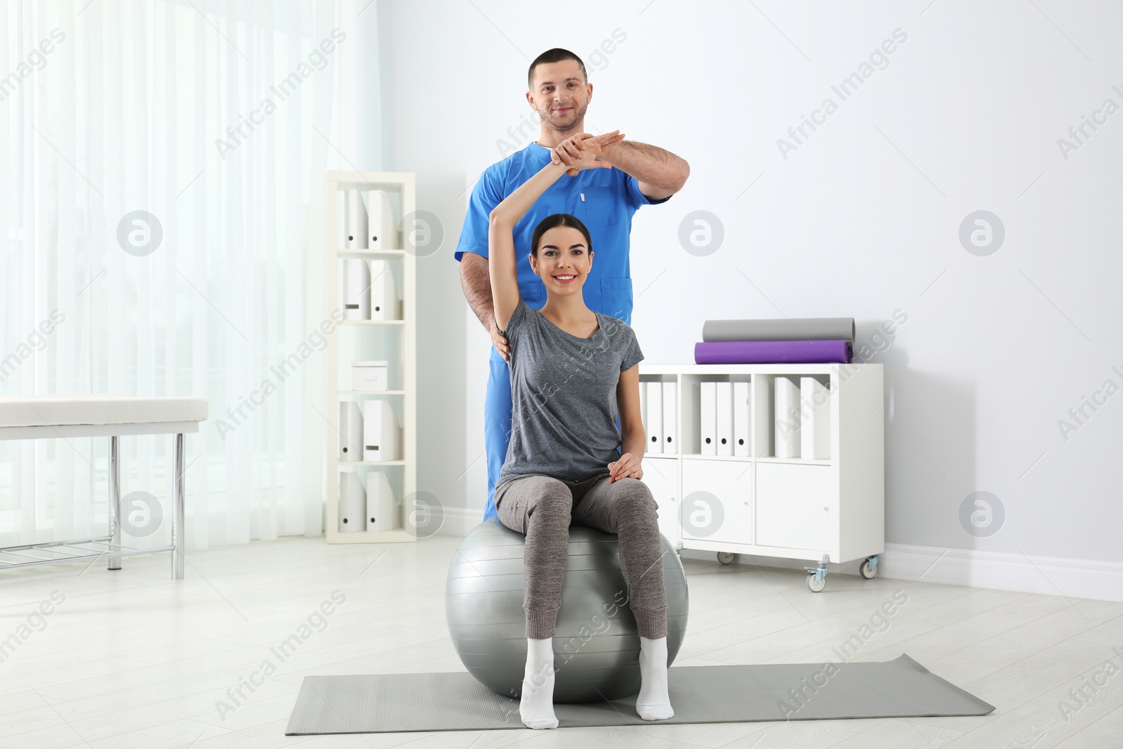 Photo of Doctor working with patient in hospital. Rehabilitation exercises