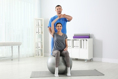 Photo of Doctor working with patient in hospital. Rehabilitation exercises