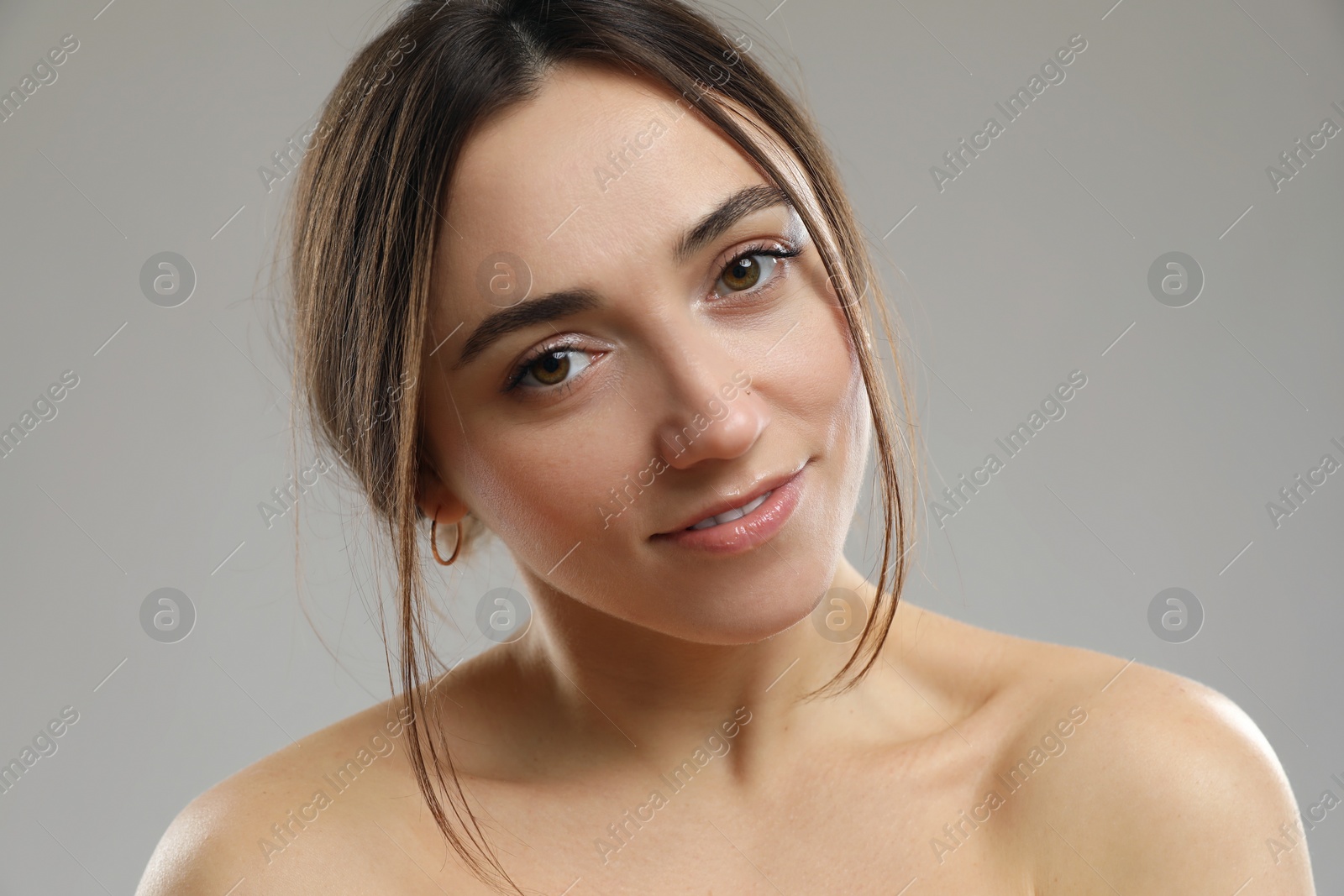 Photo of Portrait of beautiful woman on grey background