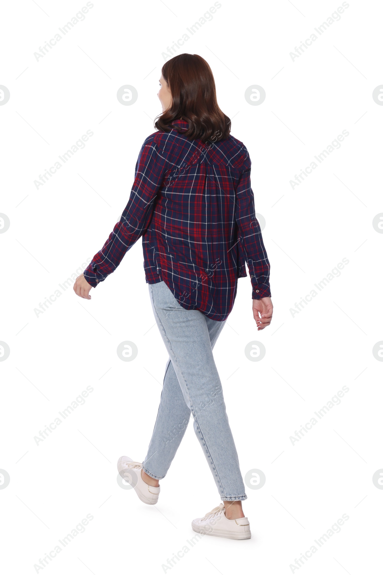 Photo of Woman in casual outfit walking on white background, back view