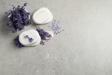 Photo of Stones, sea salt and lavender flowers on grey table, flat lay. Space for text