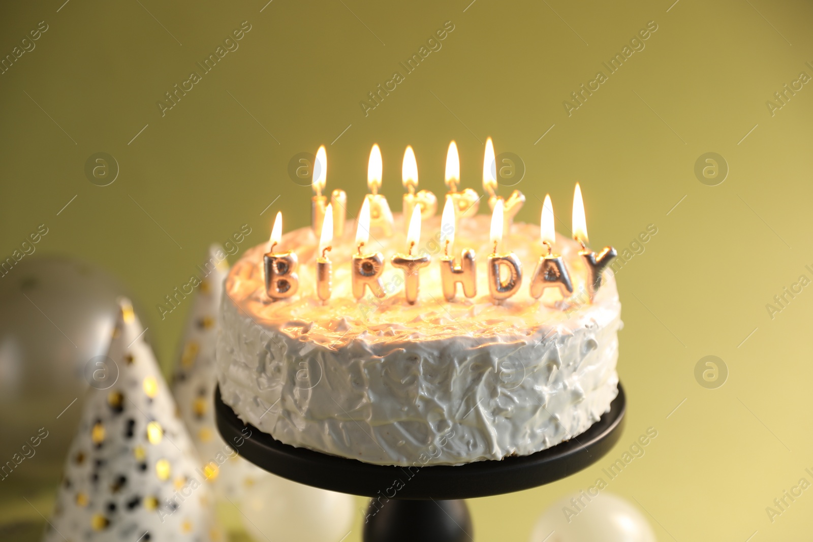 Photo of Tasty birthday cake with burning candles on green background, closeup