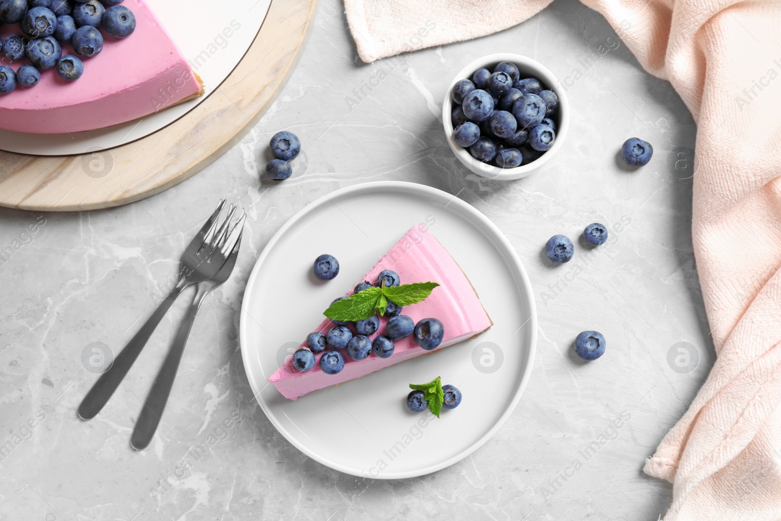 Photo of Flat lay composition of tasty blueberry cake on light grey table