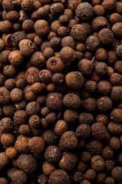 Photo of Aromatic allspice grains as background, top view