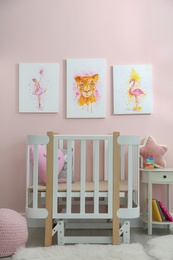 Photo of Cute pictures and crib in baby room interior