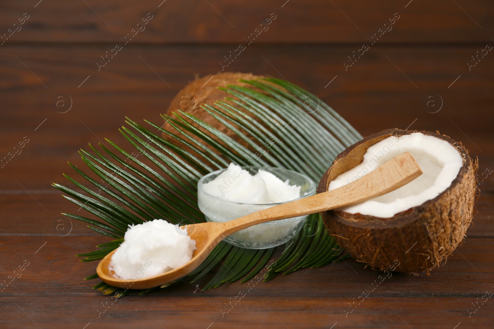 Photo of Composition with organic coconut oil on wooden table. Healthy cooking