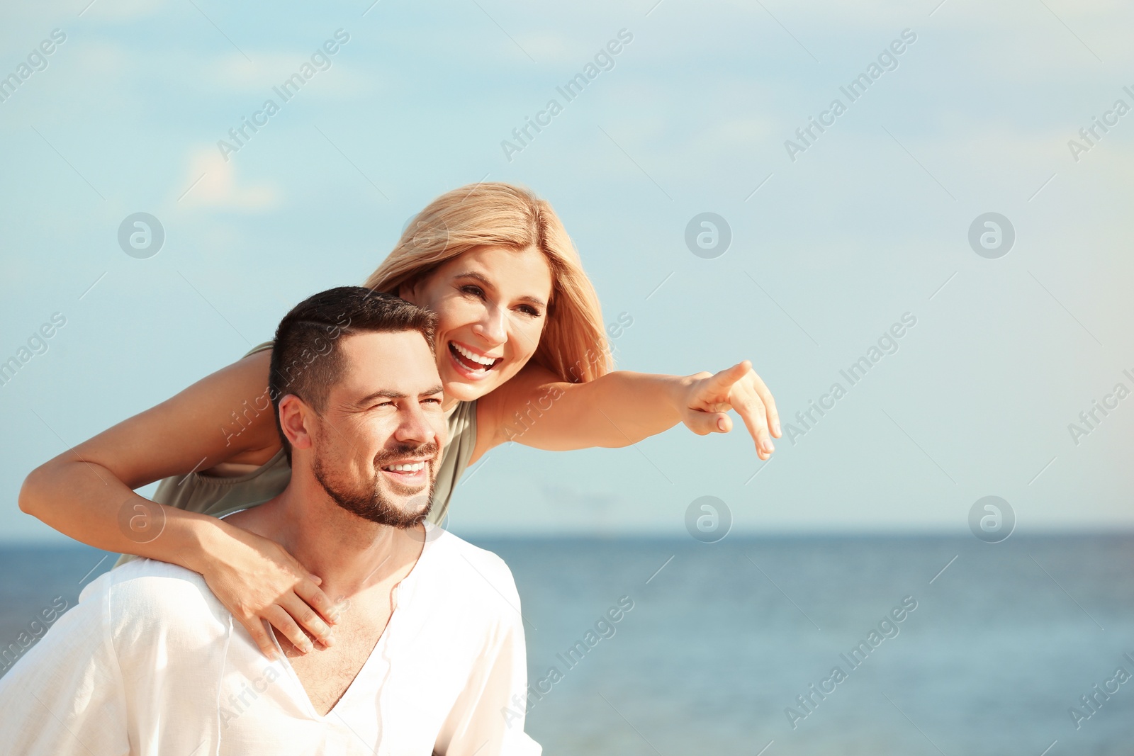 Photo of Happy romantic couple on beach, space for text