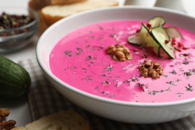 Photo of Delicious cold summer beet soup on table, closeup