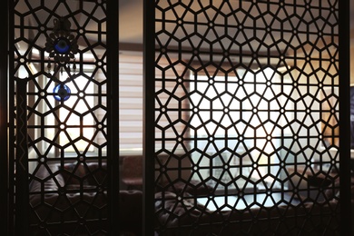 Photo of Interior of living room, view through decorative room divider