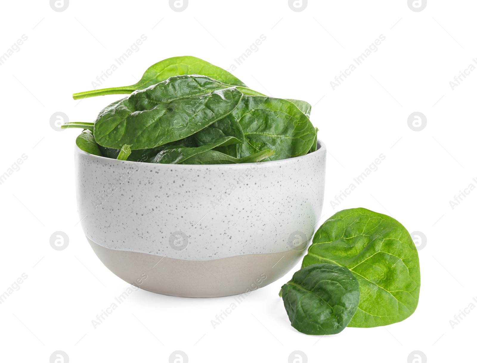 Photo of Fresh green healthy baby spinach leaves in ceramic bowl isolated on white