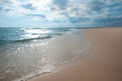 Sea waves rolling onto sandy tropical beach