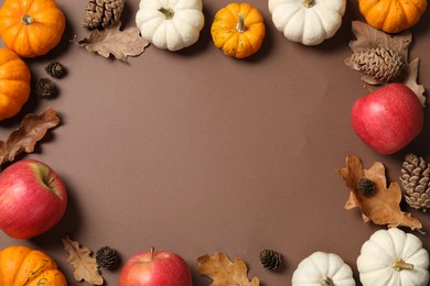 Photo of Thanksgiving day. Flat lay composition with pumpkins on brown background, space for text