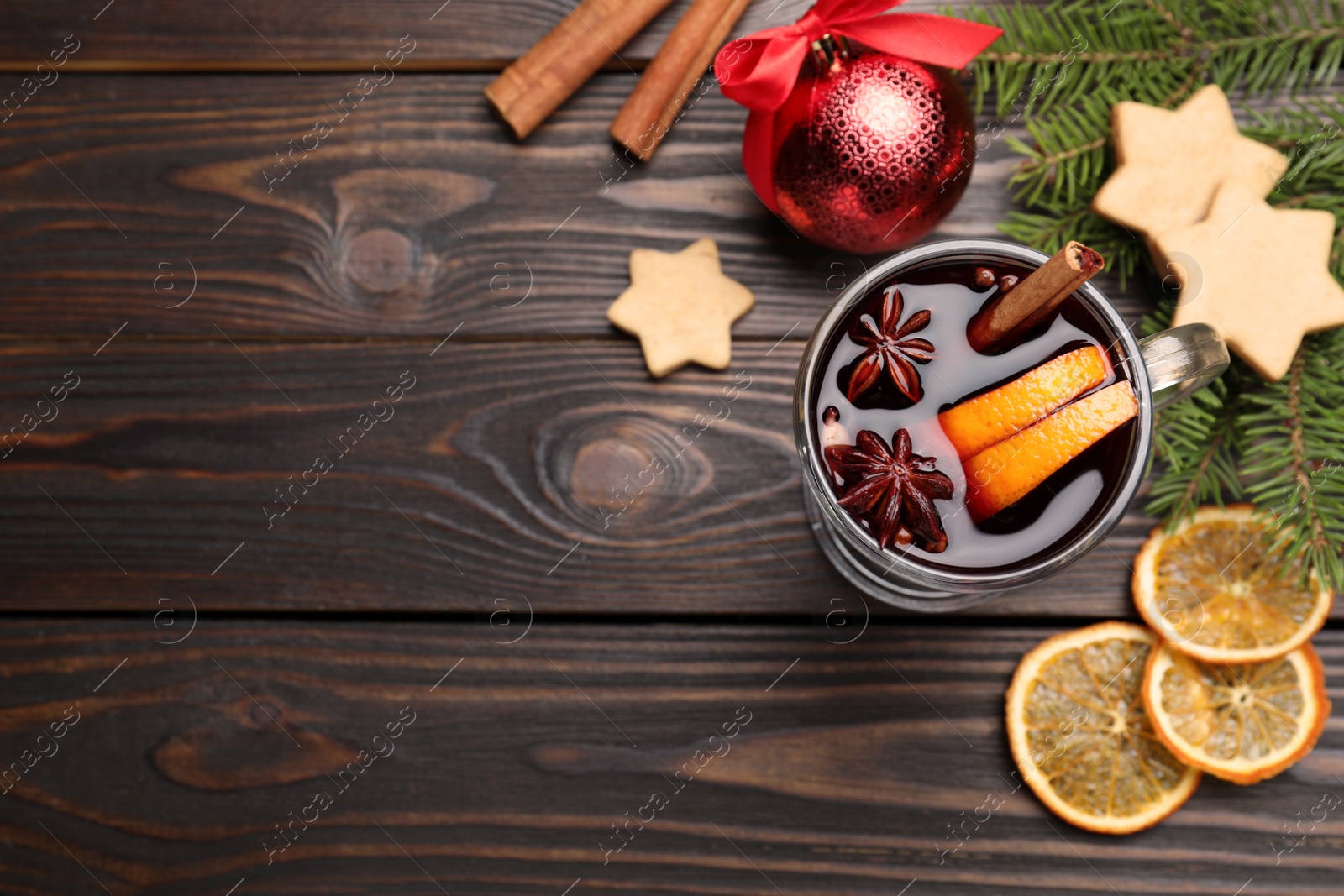 Photo of Flat lay composition with aromatic mulled wine on wooden table. Space for text