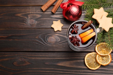 Flat lay composition with aromatic mulled wine on wooden table. Space for text