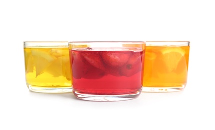 Tasty jelly desserts in glasses on white background