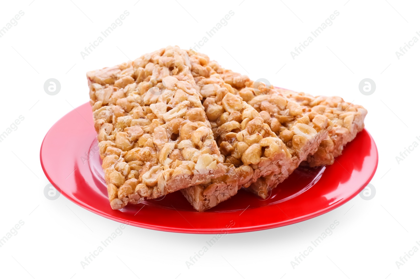 Photo of Plate with tasty peanut bars (kozinaki) isolated on white