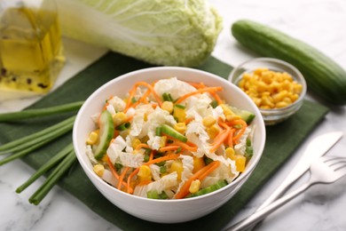 Tasty salad with Chinese cabbage served on white marble table