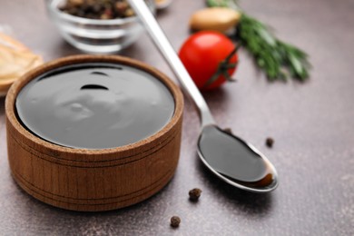 Organic balsamic vinegar and cooking ingredients on grey table, closeup