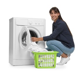 Photo of Beautiful woman taking laundry out of washing machine on white background