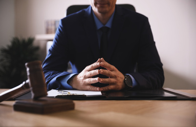 Male lawyer at table in office, closeup