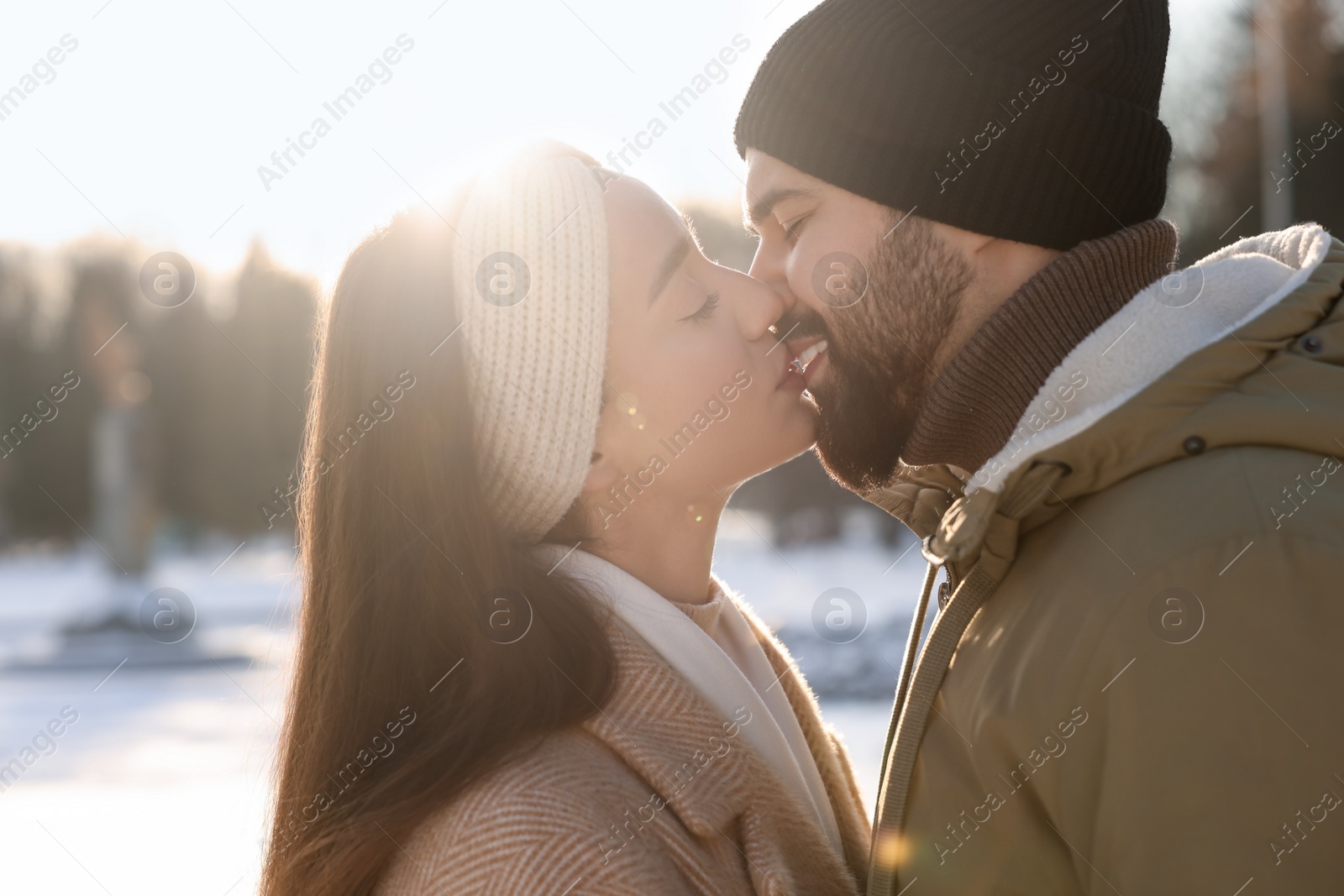 Photo of Beautiful happy couple in snowy park on winter day