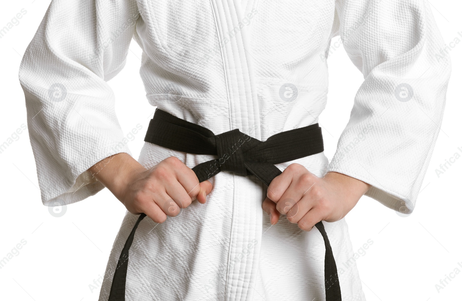 Photo of Martial arts master in keikogi with black belt on white background, closeup