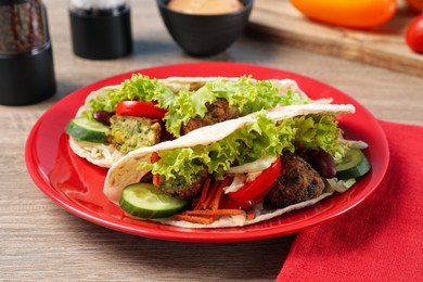 Photo of Delicious fresh vegan tacos served on wooden table