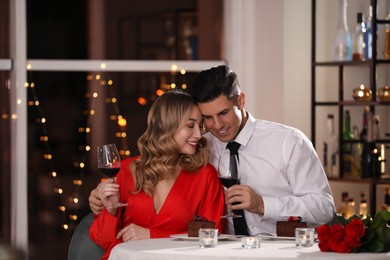 Lovely couple having romantic dinner on Valentine's day in restaurant