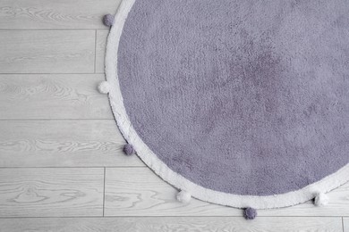 Photo of Stylish soft rug on floor, top view