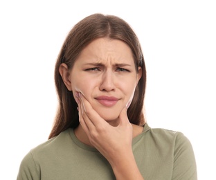 Young woman suffering from toothache on white background