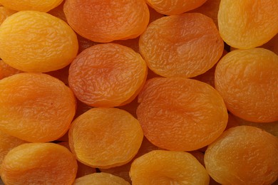 Photo of Tasty dried apricots as background, top view. Healthy snack