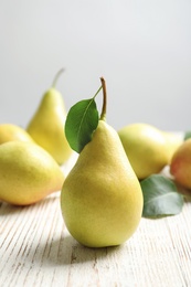 Photo of Ripe pears on wooden table. Healthy snack