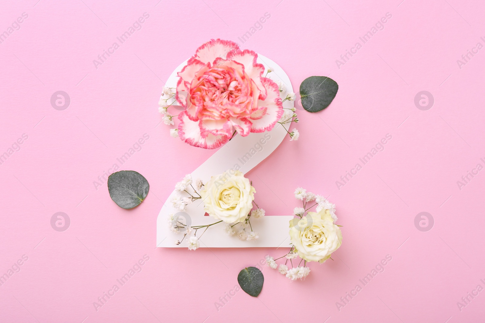 Photo of Paper number 2, eucalyptus leaves and beautiful flowers on pink background, flat lay