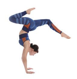 Professional young acrobat exercising on white background