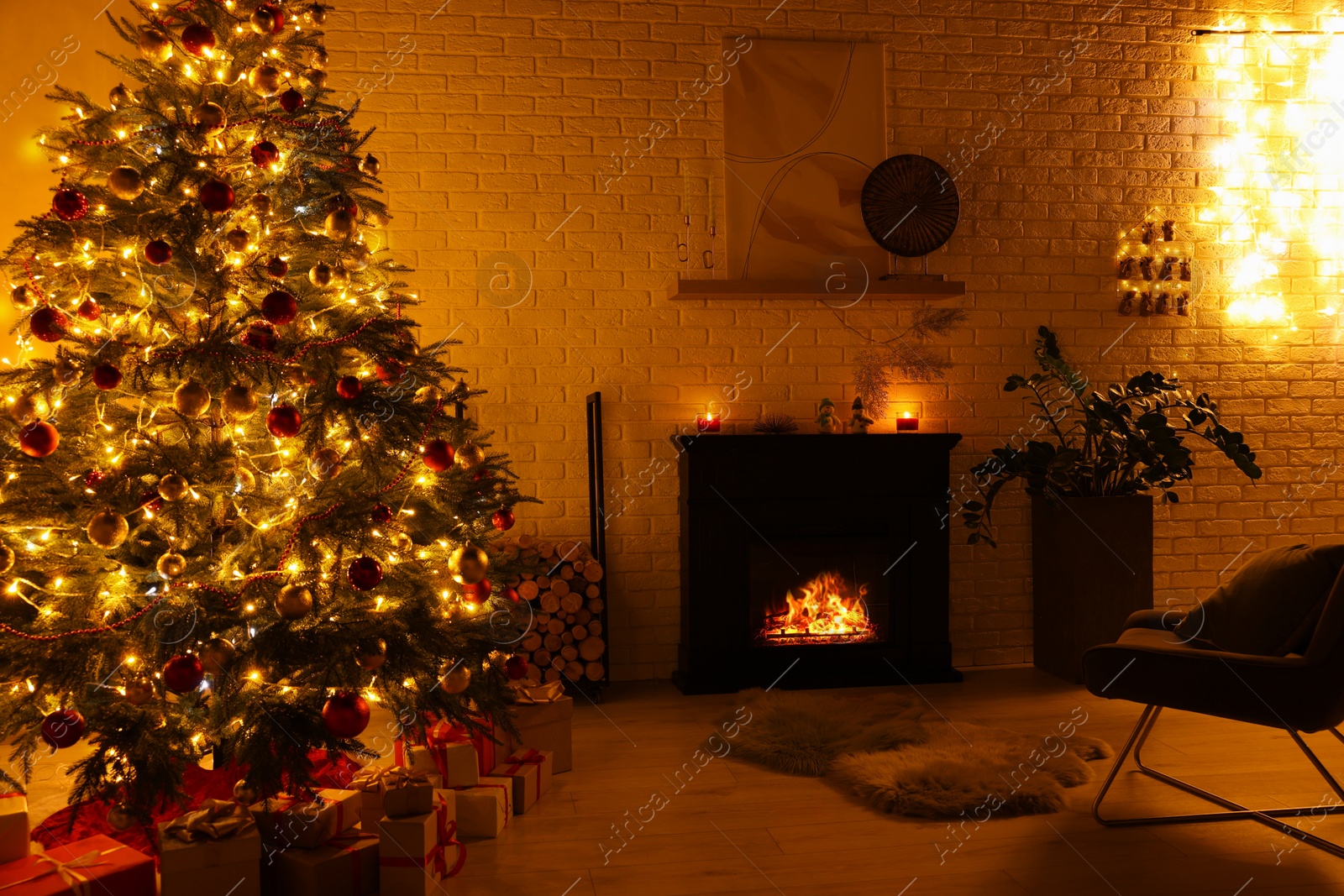 Photo of Beautiful Christmas tree with festive lights near fireplace in room. Interior design