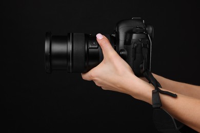 Photo of Photographer with camera on black background, closeup