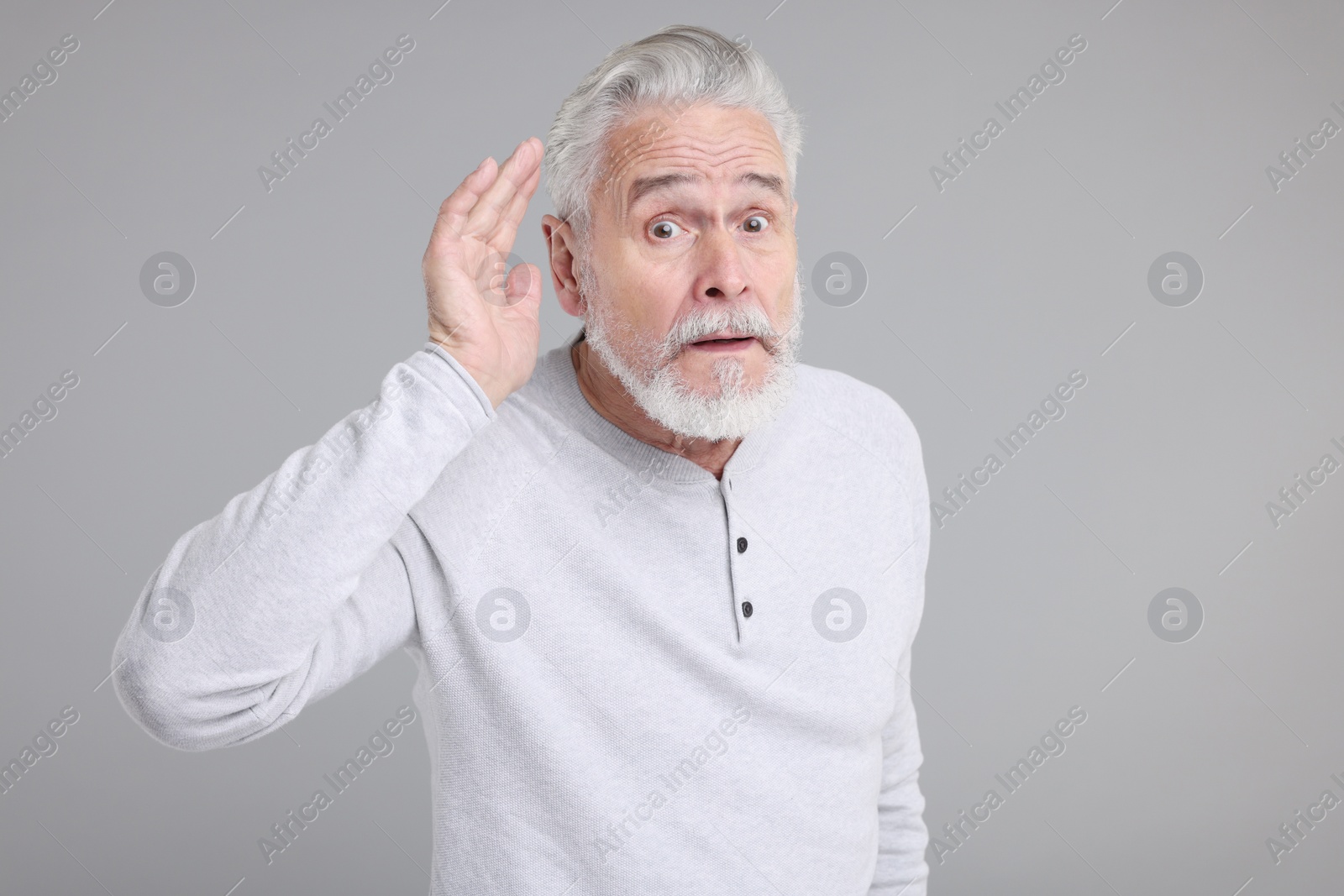 Photo of Portrait of surprised senior man on grey background